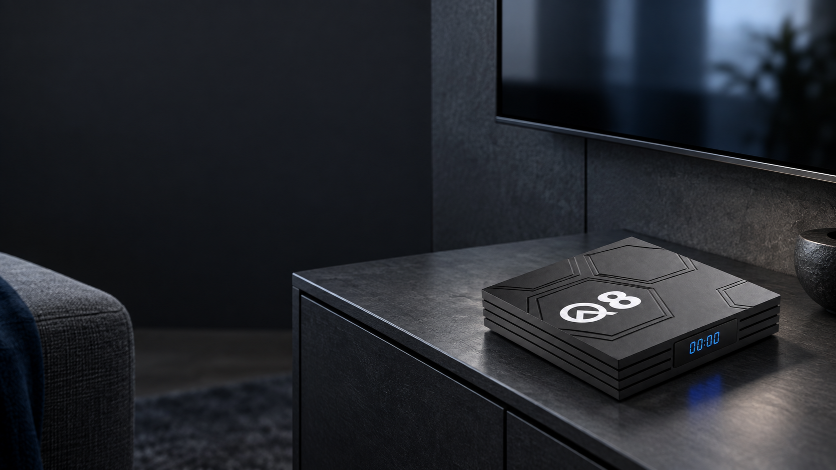 Q8 media box on a graphite console beside a television